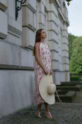 a lady in an off the shoulder pink floral printed dress